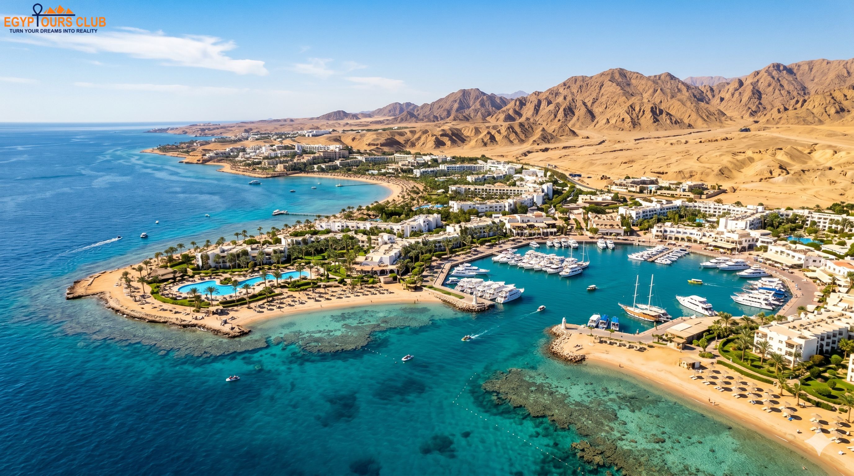 >Aerial view of Sharm El Sheikh with turquoise Red Sea water, resorts, and desert mountains